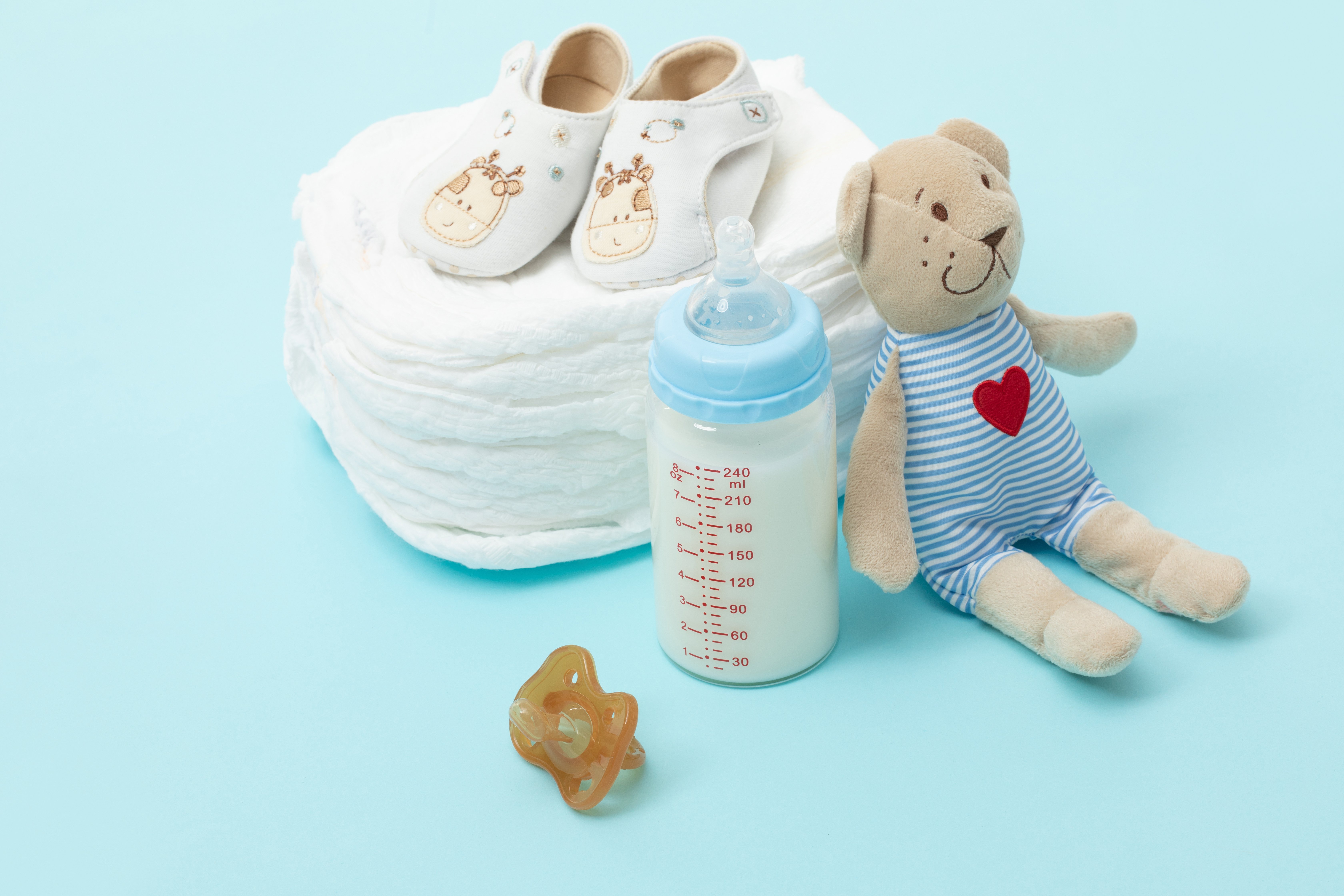 Lovepik_com-501637763-maternal-and-child-supplies-diapers-baby-bottle-nipple-toddler-s.jpg
